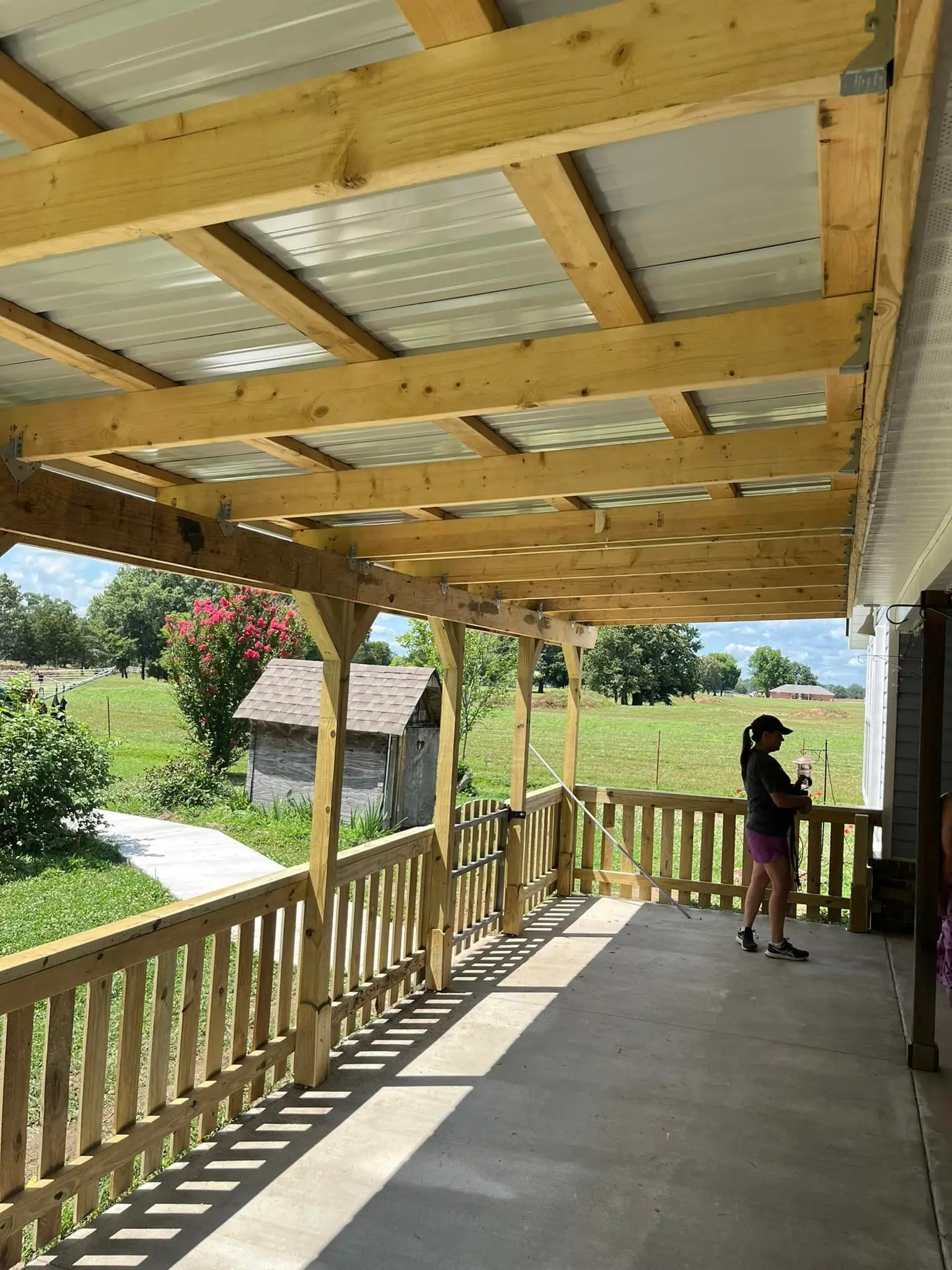 extended wood and concrete deck with patio cover